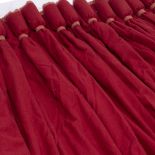 A PAIR OF LARGE RED FINE WOOLEN INTERLINED CURTAINS with gathered tops, each curtain approximately