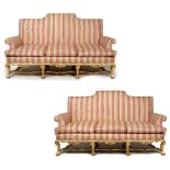 AN ANTIQUE CHIPPENDALE STYLE GILT THREE SEATER SOFA with scroll centred back and arms, striped