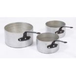 A SET OF THREE FRENCH ALUMINIUM AND IRON LARGE SAUCEPANS stamped Matfer, the largest 32cm diameter x