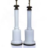 TWO SIMILAR 19TH CENTURY WHITE GLASS FACETED LAMP BASES each 66cm high and approximately 16cm