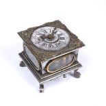 A 16TH CENTURY STYLE SILVERED GERMAN TABLE CLOCK with cherub spandrels and engraved dial with