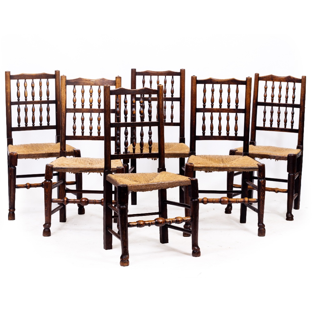 A SET OF SIX ANTIQUE NORTH COUNTRY RUSH SEATED SPINDLE BACK CHAIRS, 50cm wide x 97cm high (6)