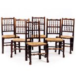 A SET OF SIX ANTIQUE NORTH COUNTRY RUSH SEATED SPINDLE BACK CHAIRS, 50cm wide x 97cm high (6)