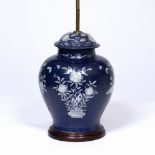 A TABLE LAMP CONSTRUCTED FROM AN ORIENTAL JAR AND COVER with blue ground and white enamel flower