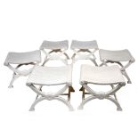 A SET OF SIX GEORGIAN STYLE WHITE PAINTED X FRAMED STOOLS with shaped seats, each 52cm wide x 44cm