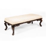 A 19TH CENTURY RECTANGULAR STOOL with overstuffed upholstered seat, carved frieze and cabriole legs,