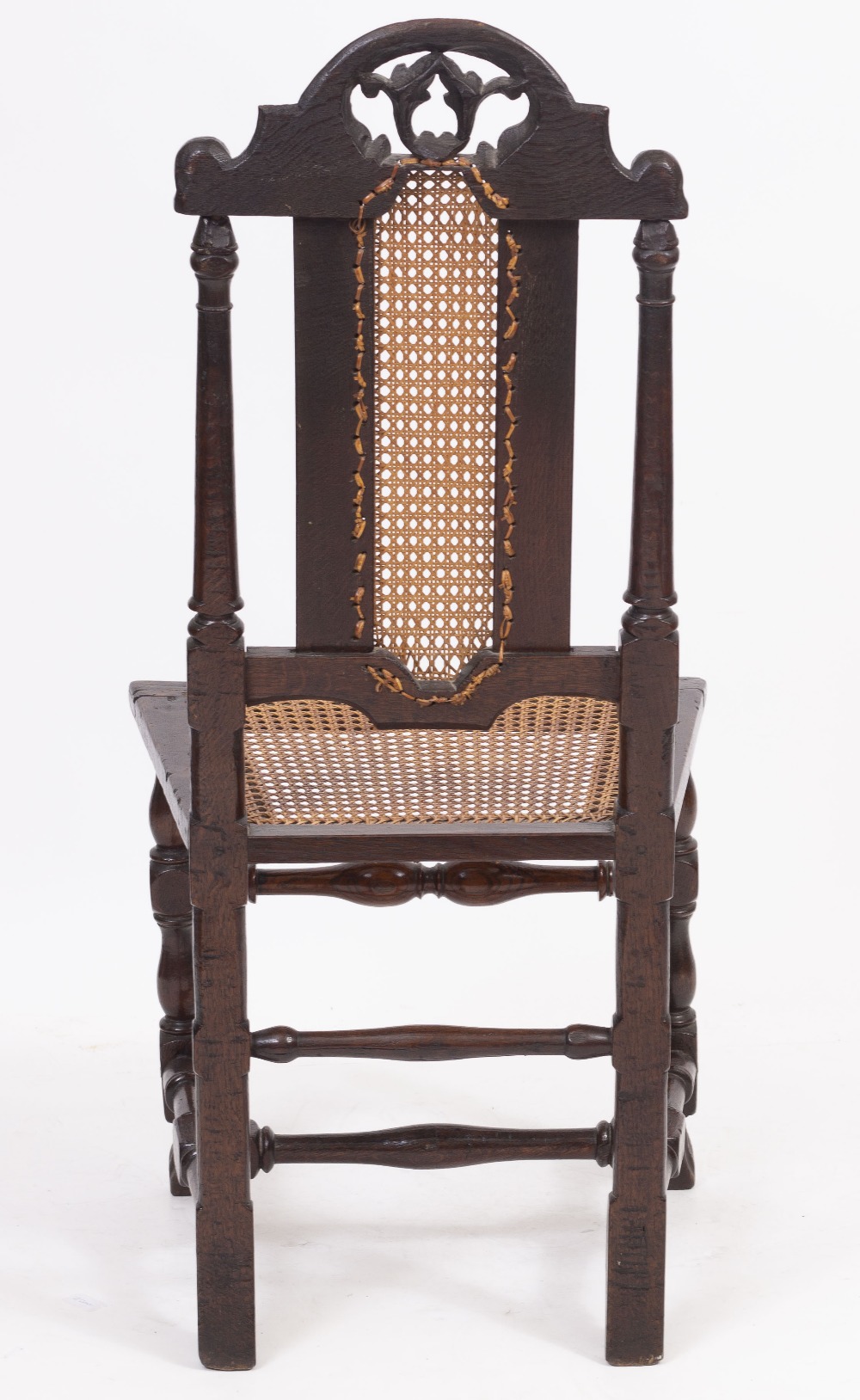 A CAROLEAN OAK SIDE CHAIR with arching pierced foliate crest, caned back and seat and turned legs - Bild 3 aus 4