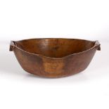 AN ANTIQUE CARVED HARDWOOD FEASTING BOWL with shaped ends, 40.5cm wide x 33cm deep x 14.5cm high (