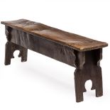 AN ANTIQUE RUSTIC BOARDED OAK LONG STOOL with shaped end supports, 154 x 27.5 x 49cm