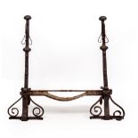 A PAIR OF 17TH CENTURY WROUGHT IRON FIRE DOGS with faceted finials on scrolling feet to the front,