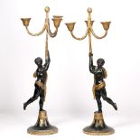 A PAIR OF 19TH CENTURY PARCEL GILT AND BLACK PAINTED GESSO MOULDED CANDELABRA in the form of