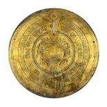A CIRCULAR ENGRAVED BRASS SUN DIAL PLATE with central mask and motto, 29cm diameter