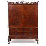 A MID 18TH CENTURY AND LATER MAHOGANY PRESS CUPBOARD with fretwork cresting, the twin doors