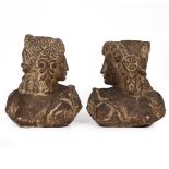 A PAIR OF ANTIQUE CARVED STONE SCULPTURAL HEADS with tied head dresses and each looking over their