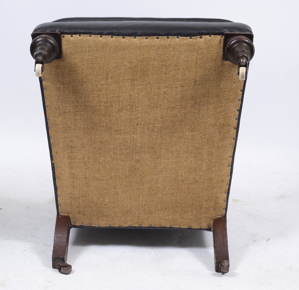 A VICTORIAN LEATHER UPHOLSTERED DEEP ARMCHAIR with button back, turned front legs and ceramic - Image 4 of 4