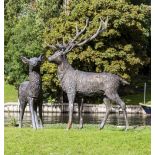 A PAIR OF BRONZE GARDEN SCULPTURES in the form of a stag and a doe, the stag approximately 190cm