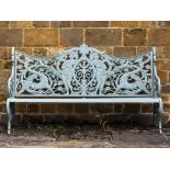 A VICTORIAN GREEN PAINTED CAST IRON GARDEN SEAT the pierced back decorated with men armed with