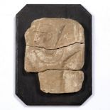 A SMALL SANDSTONE CARVING IN THE EGYPTIAN MANNER with traces of paint, 12cm wide x 15.5cm high,