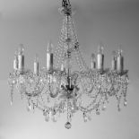 A MODERN NINE BRANCH CUT GLASS ELECTROLIER OR CHANDELIER with twisted scrolling stems, hanging swags
