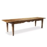 AN ANTIQUE RECTANGULAR KITCHEN TABLE the hardwood twin plank top with cleated ends, on a base with