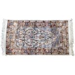 A SMALL ORIENTAL WOOL PRAYER MAT with foliate tree design and triple banded border, 110 x 60cm;