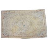 A GOLD GROUND AUBUSSON STYLE NEEDLEWORK RUG, the central oval ornament framing a spray of flowers,