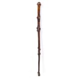 A GEORGE III FOLK ART HAWTHORN WALKING CANE with scratch carved decoration depicting faces and