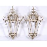 A PAIR OF WHITE PAINTED WROUGHT IRON HANGING HEXAGONAL LANTERNS with acanthus leaf scrolling
