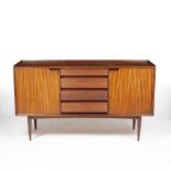 A LATE 20TH CENTURY TEAK SIDEBOARD with four central drawers with fluted fronts, flanked by twin