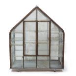 A WROUGHT IRON GLAZED MINIATURE GREENHOUSE OR FERN HOUSE with pitched roof and shelves within, the