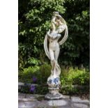 A CAST RECONSTITUTED STONE GARDEN SCULPTURE in the form of Venus standing on a sphere and