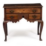 A GEORGE III COUNTRY MADE OAK LOWBOY with inverted front corners and a long drawer over central