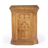 A VICTORIAN OAK GOTHIC REVIVAL PLINTH with castellated top and cupboard to the front, 56cm wide x