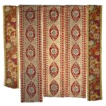 A SET OF THREE OLD HANGING WOOLEN NEEDLEWORK PANELS centrally decorated with passion flowers