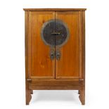 A CHINESE HARDWOOD TWO DOOR CUPBOARD with oversized circular brass lock plate and engraved