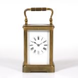 A FRENCH BRASS FIVE GLASS CARRIAGE CLOCK with striking mechanism, the enamelled dial with roman