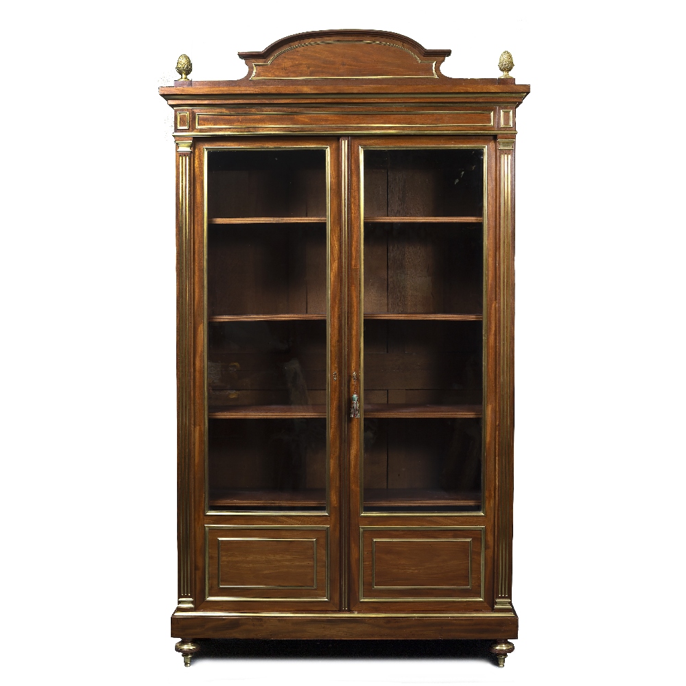 A FRENCH 19TH CENTURY MAHOGANY AND BRASS MOUNTED BOOKCASE with shaped crest, cast pineapple