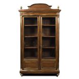 A FRENCH 19TH CENTURY MAHOGANY AND BRASS MOUNTED BOOKCASE with shaped crest, cast pineapple