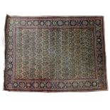 A GREEN GROUND SMALL RUG with hooked designs to the central field within a multiple banded border,