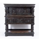 A 16TH OR 17TH CENTURY OAK COURT CUPBOARD with carved cornice, twin panelled doors with hidden locks