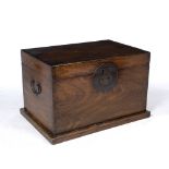 AN ORIENTAL HARDWOOD BOX OR TRUNK with metal lock plate and carrying handles to the side, 83.5cm