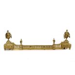 A 19TH CENTURY CONTINENTAL CAST BRASS FENDER with urn finials and pierced decoration, of