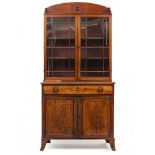 A REGENCY MAHOGANY SECRETAIRE BOOKCASE the arching top over twin astragal glazed doors with two