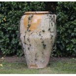 A TERRACOTTA HONEY GLAZED JAR with lug handles, 45cm diameter x 70cm high