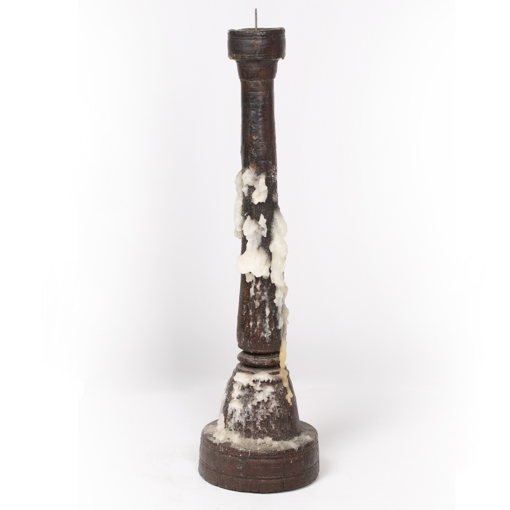 A TURNED AND CARVED HARDWOOD PRICKET CANDLESTICK 17cm diameter at the base x 63cm high