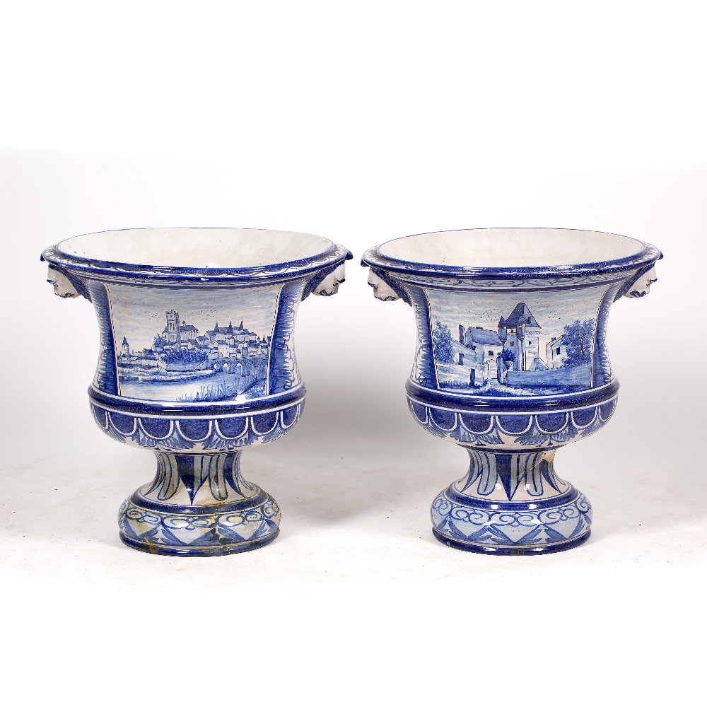 A PAIR OF LARGE CONTINENTAL TIN GLAZED VASES of campana form, decorated with lion masks and