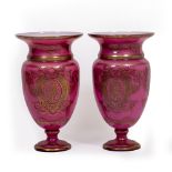 A PAIR OF GLASS PINK GROUND PARCEL GILT VASES with flaring rims, 27cm diameter x 47cm high