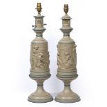 A PAIR OF PAINTED CAST METAL TABLE LAMPS decorated with classical scenes on turned spreading