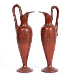 A PAIR OF REDWARE POTTERY TYPE EWERS of classical form decorated with bands of stylized leaves, 39.
