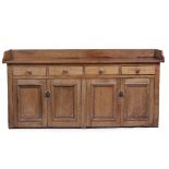 A LATE VICTORIAN PINE KITCHEN DRESSER with raised back and sides, four drawers with turned knob